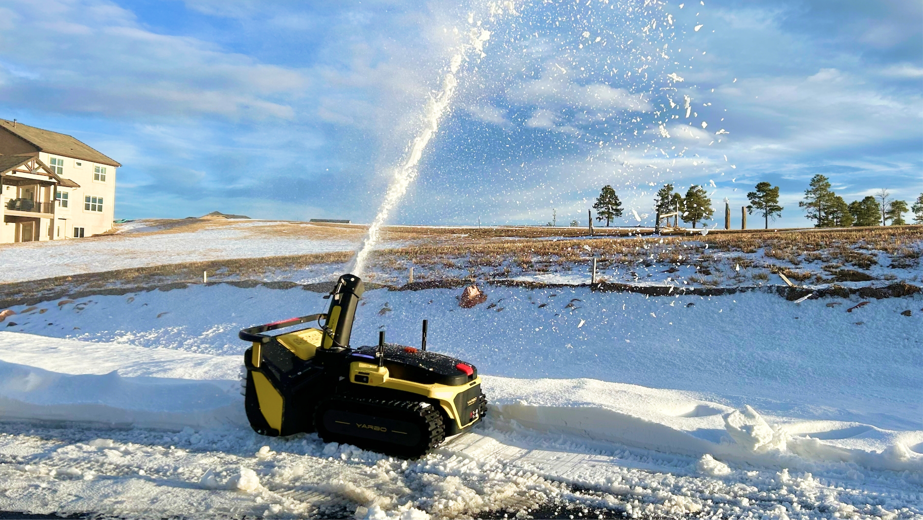 Yarbo snow blower effectively clearing heavy wet snow from a driveway.