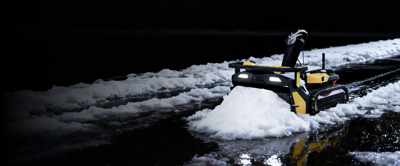 Yarbo snow blower clearing snow at night