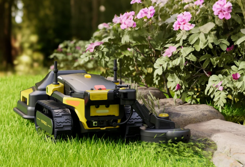 Yarbo Trimmer on grass with pink flowers in the background
