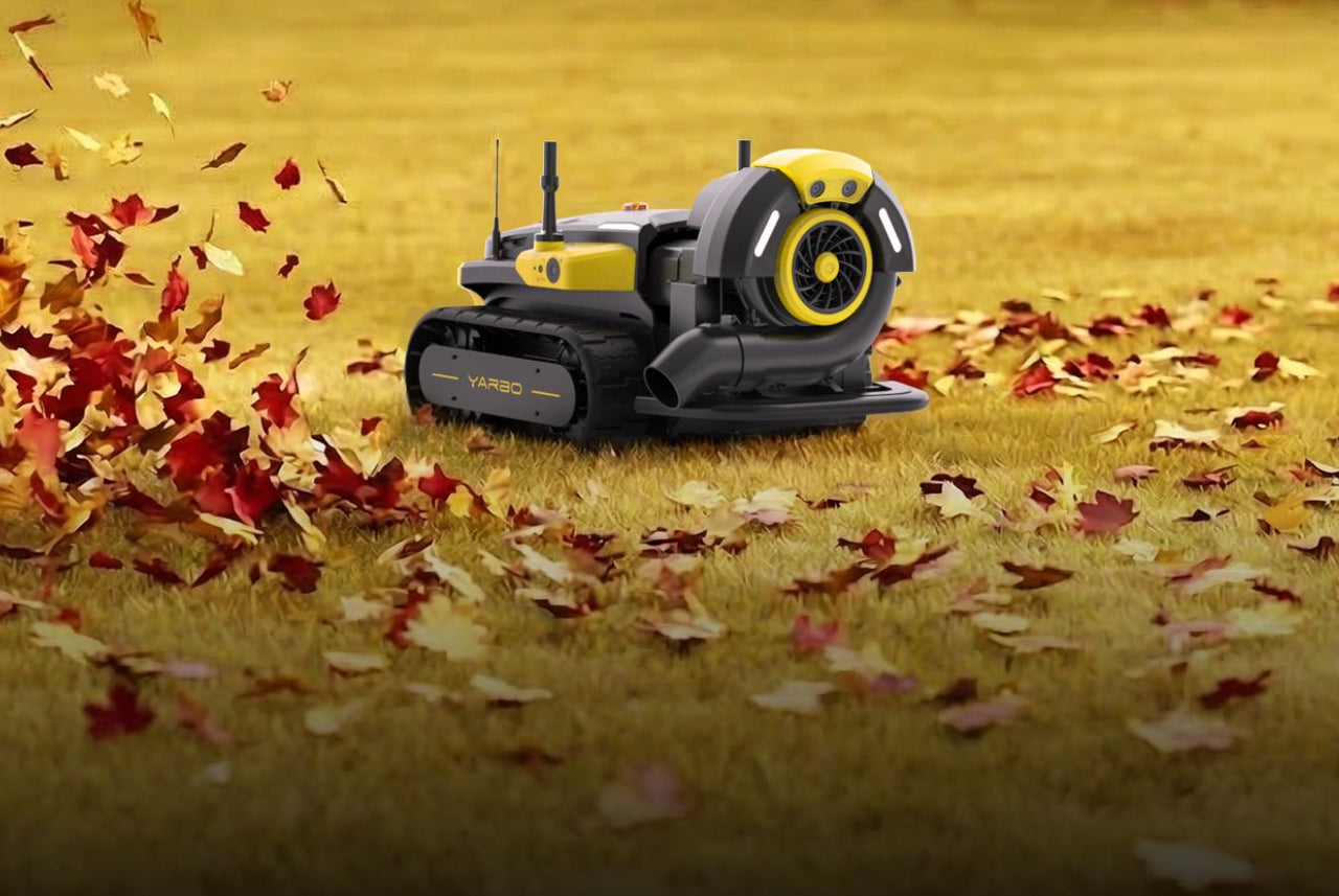 Yarbo cleaning on a grassy field with fallen leaves