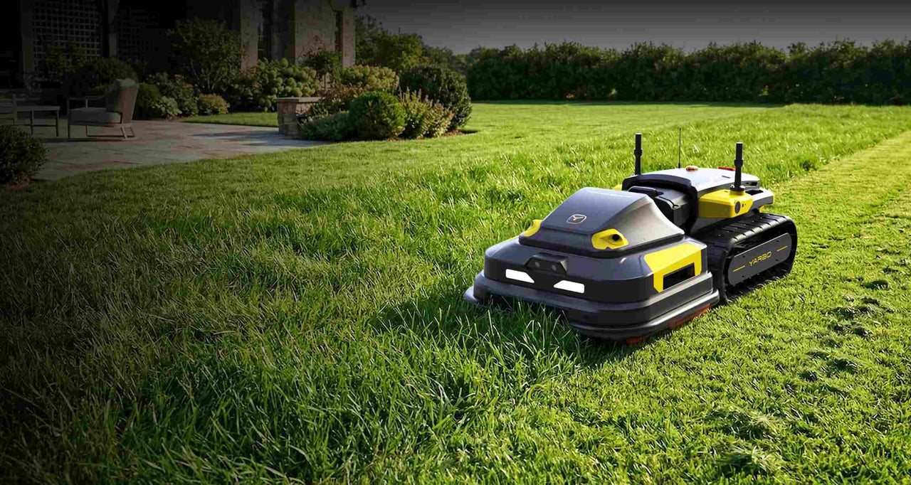 Yarbo robot on a grassy lawn with a house and garden in the background